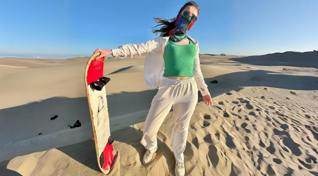 Sanboarding down dunes in Peru